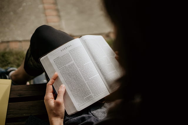 Bible on Lap Open to Ezekiel