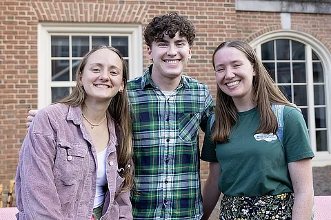 three smiling students