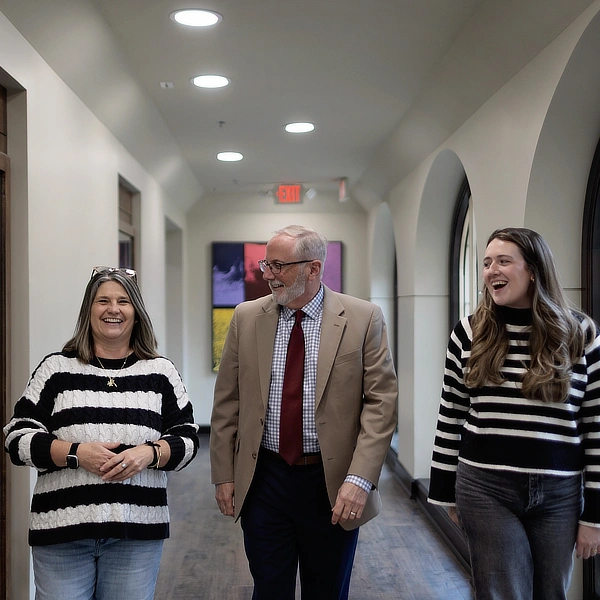 professor walking with two students