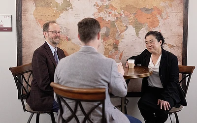 three faculty sitting at a table