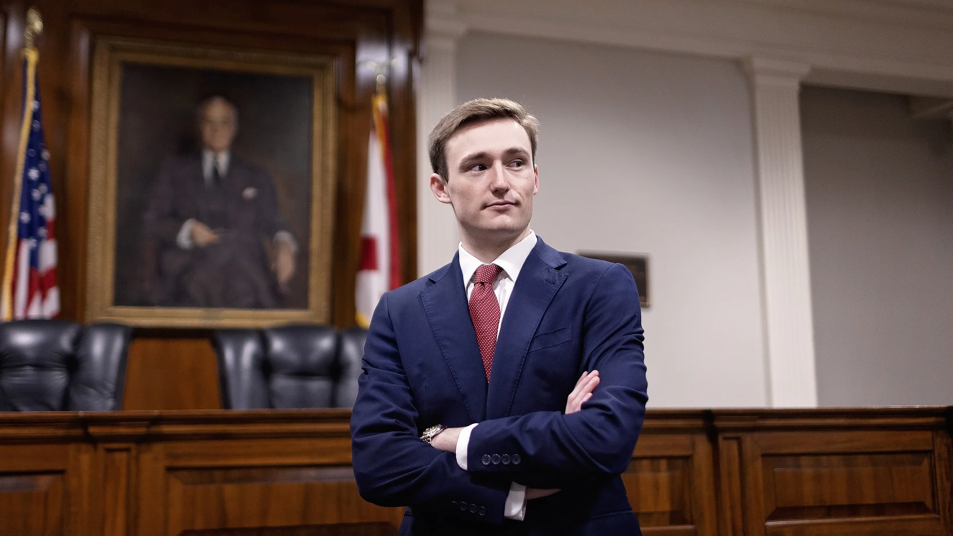 male law student standing in courtroom