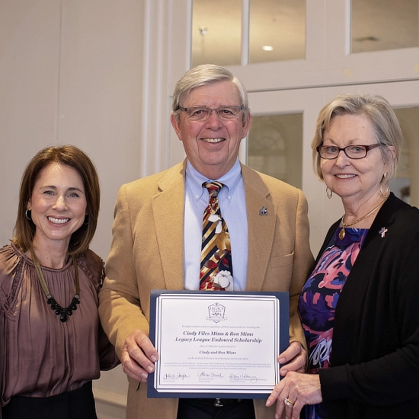 donors posing with endowed scholarship certificate