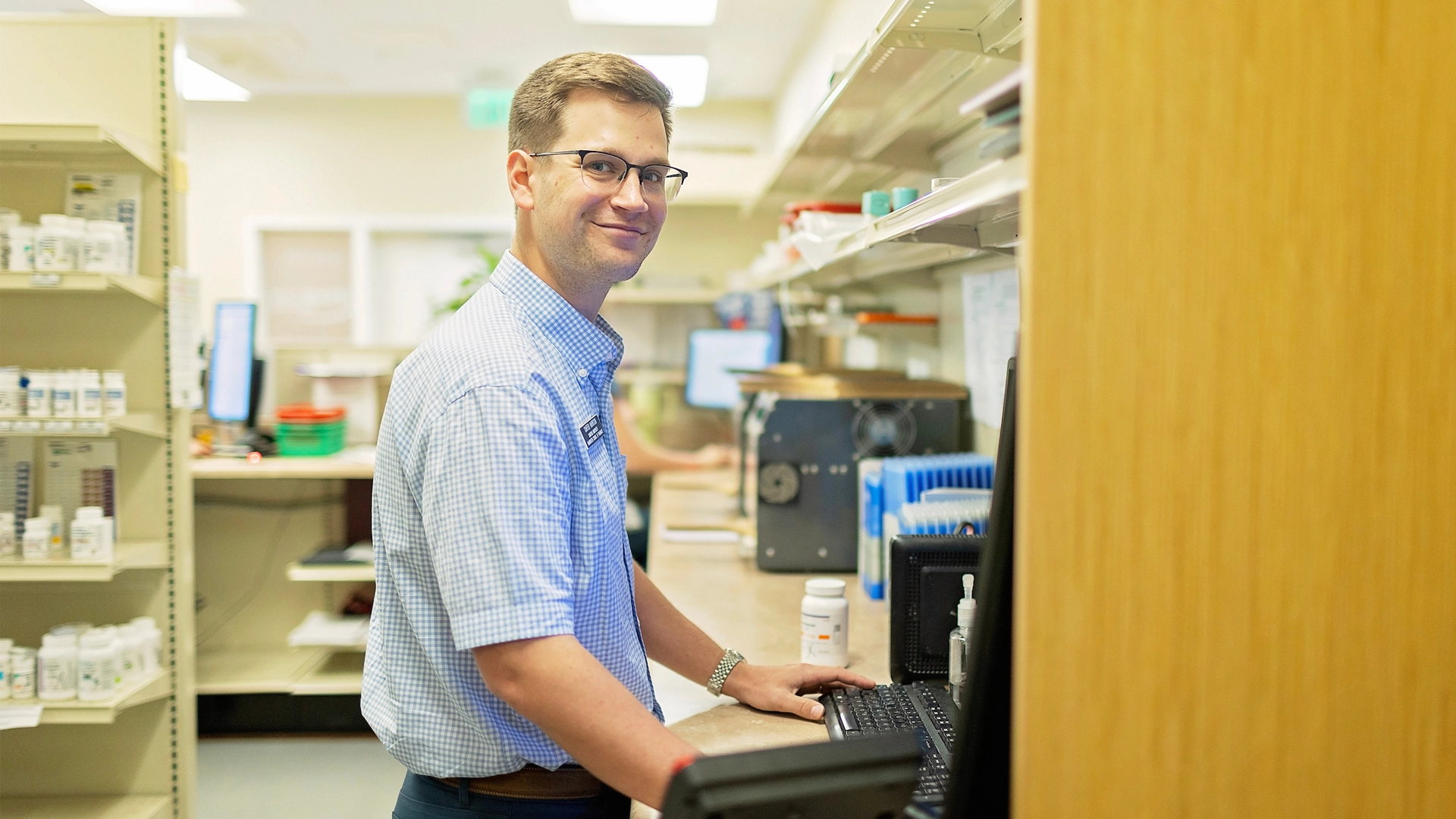 male pharmacy student working in pharmacy