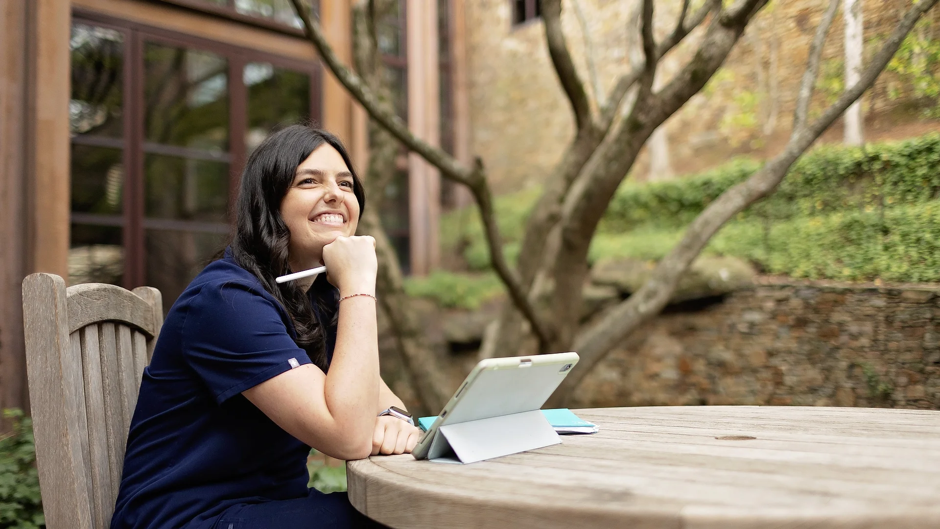 female online nursing student at a table