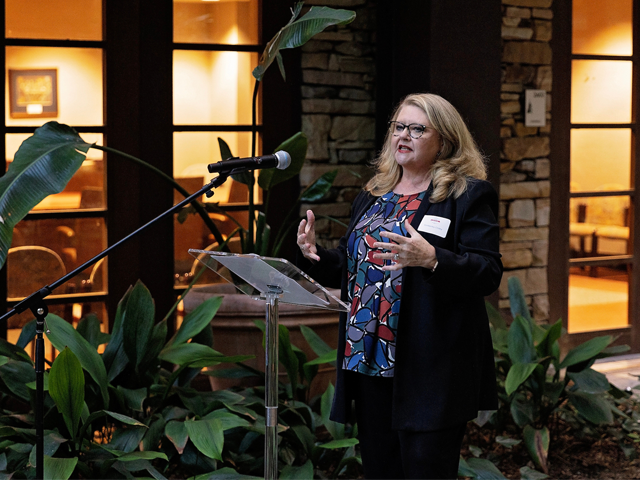 female speaking at podium