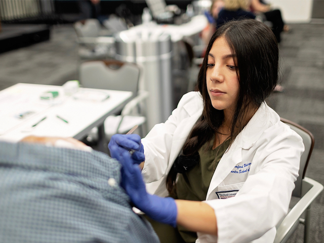 hispanic female giving vaccination