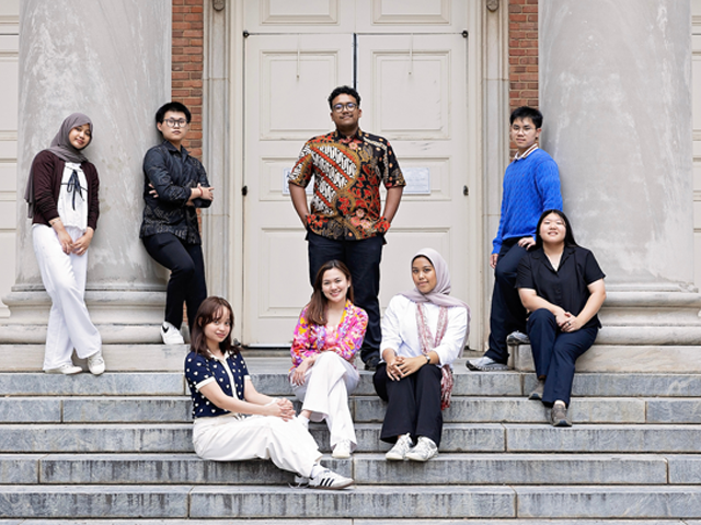male and female indonesian students sitting on steps