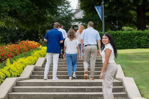 female student walking with family