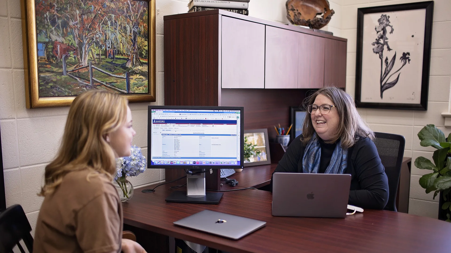 academic advisors helping a female student