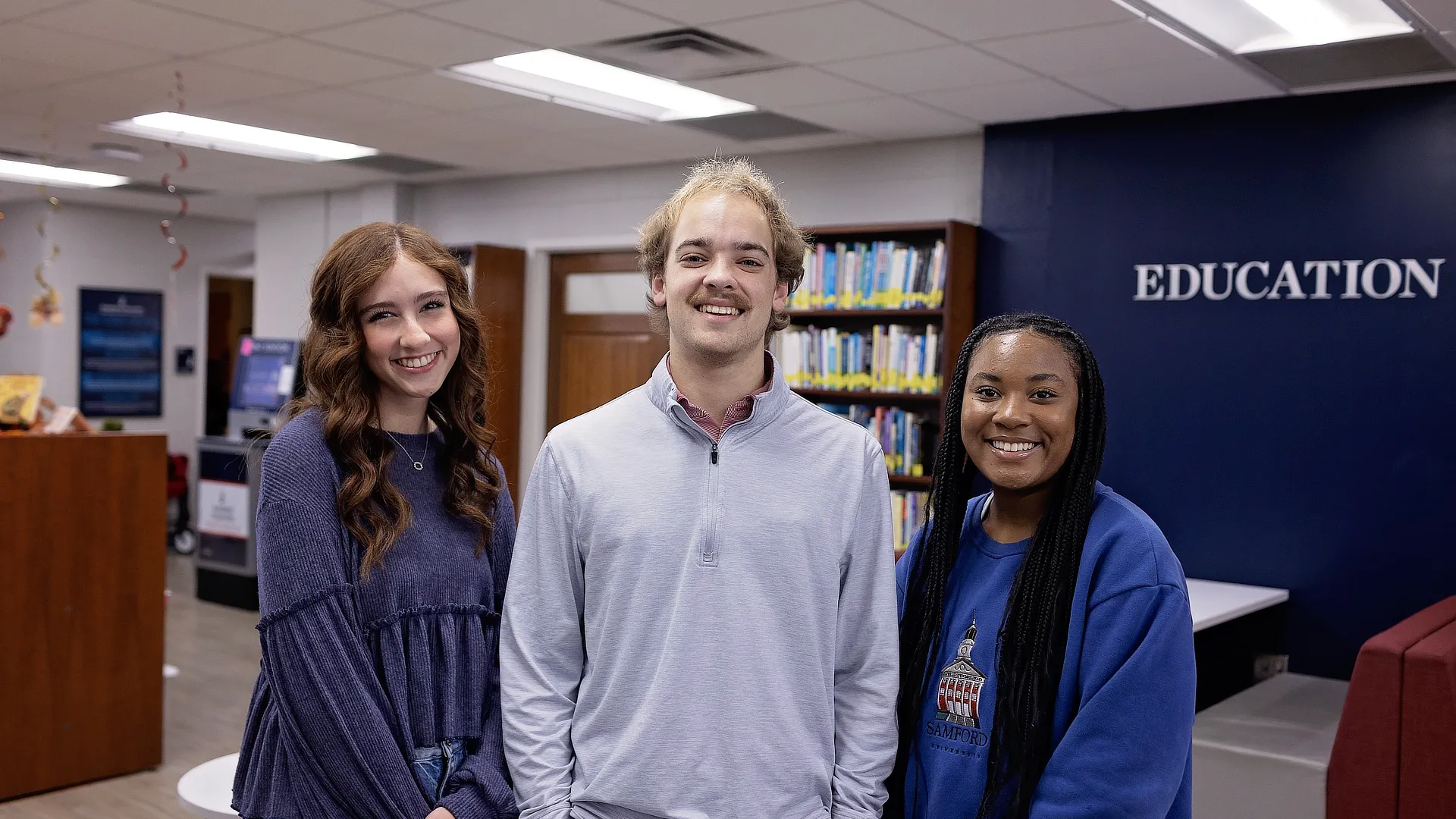three students smiling